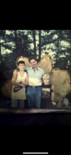 Jason Freeman as a child on the right, with his father and sibling beside a large tree